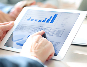 Cropped shot of a group of businesspeople looking at graphs on digital tablets