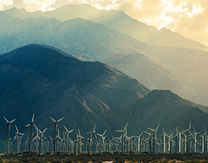 California Desert Wind Turbines in Coachella Valley. Scenic Mountains and Sun Light. California, United States.