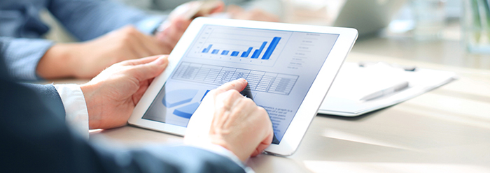 Cropped shot of a group of businesspeople looking at graphs on digital tablets